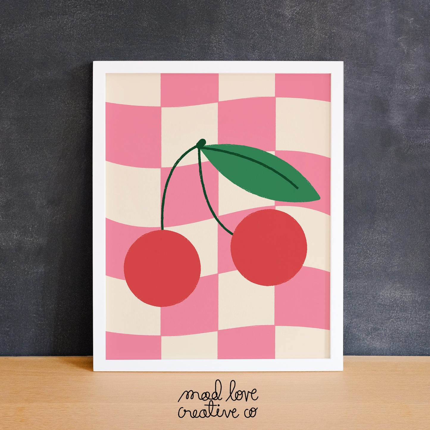 Cute print of a pair of cherries on a pink checkered background. Made in Canada by Mad Love Creative Co.