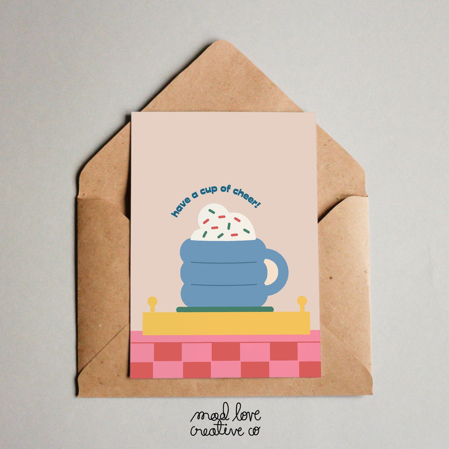 Cute Christmas card of a mug with whipped cream on a cute tray that says "have a cup of cheer". Made in Canada by Mad Love Creative Co.