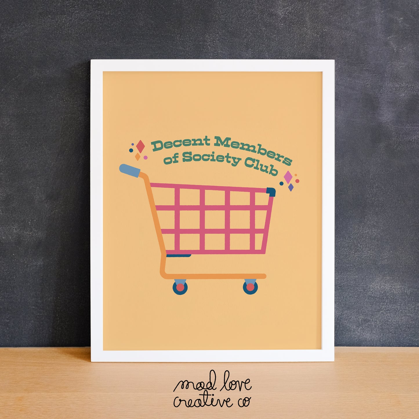 Yellow print of a colourful shopping cart that says "decent members of society club". Made in Canada by Mad Love Creative Co.
