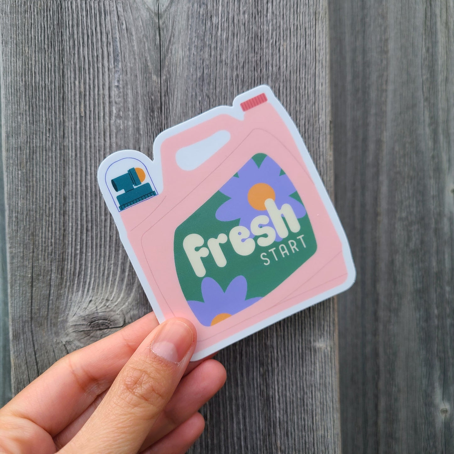Cute sticker shaped like a liquid detergent bottle that says "fresh start". Made in Canada by Mad Love Creative Co.