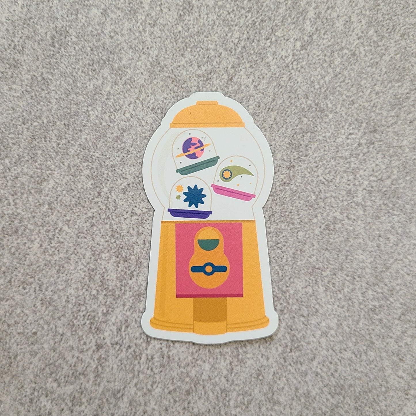 A cute capsule machine magnet with space elements. Made in Canada by Mad Love Creative Co.