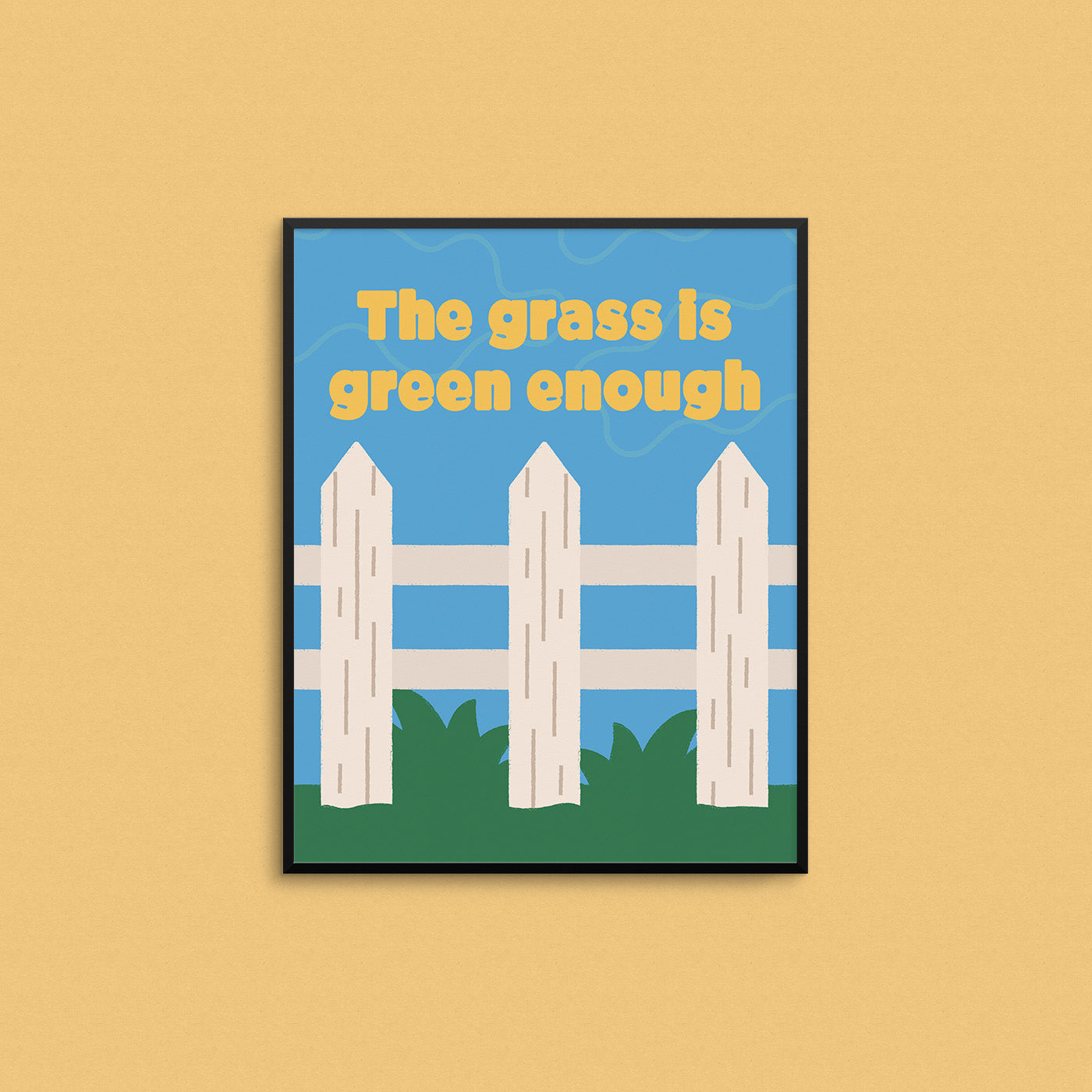 Bright print of a white picket fence on green grass with the phrase "the grass is green enough". Made in Canada by Mad Love Creative Co.