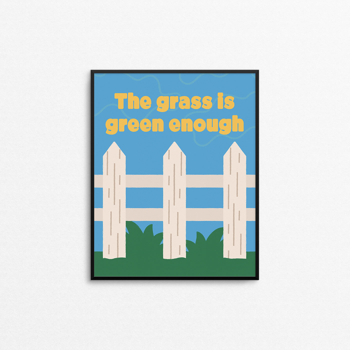 Bright print of a white picket fence on green grass with the phrase "the grass is green enough". Made in Canada by Mad Love Creative Co.