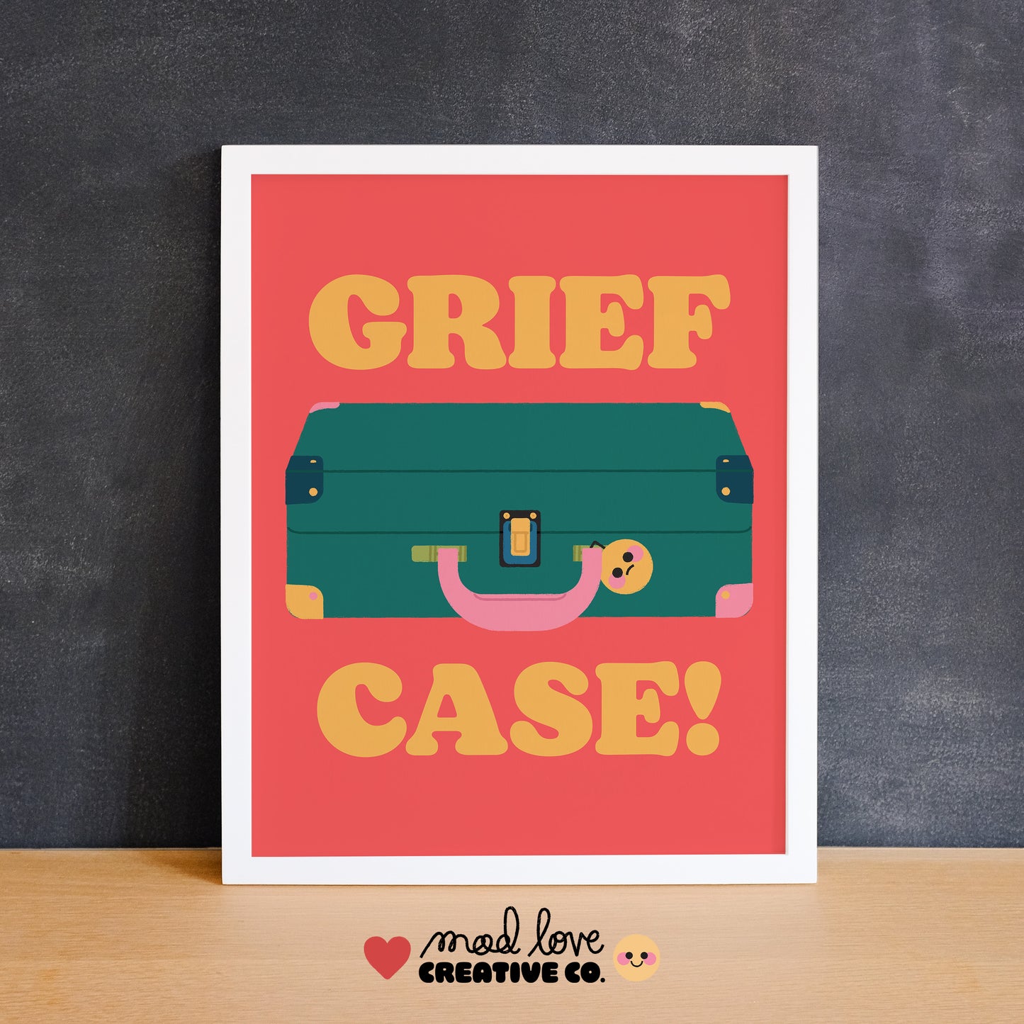 Framed artwork with a suitcase illustration and 'Grief Case!' text on a red background. Made in Canada by Mad Love Creative Co.