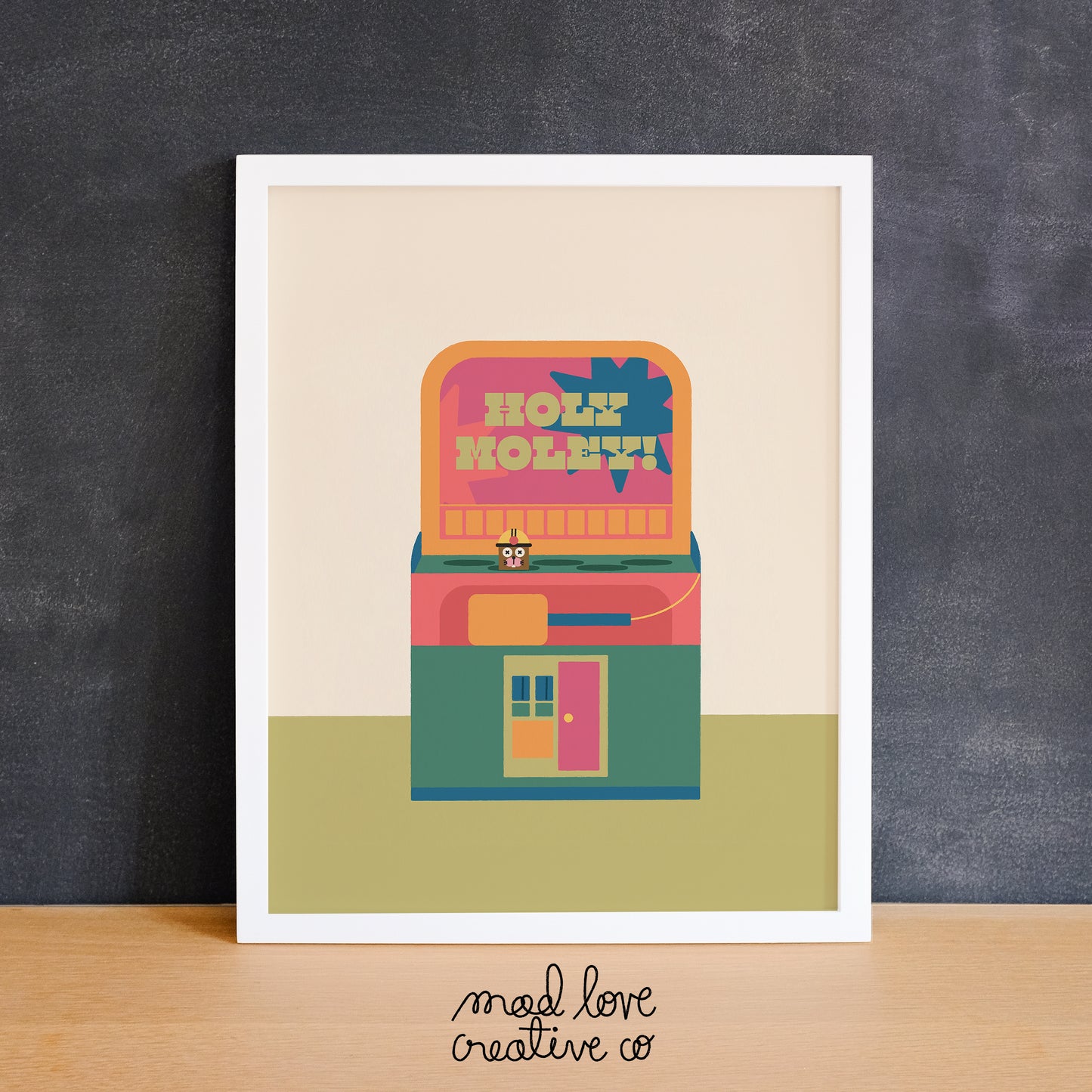Colourful print of a whack-a-mole arcade game that says "holy moley". Made in Canada by Mad Love Creative Co.