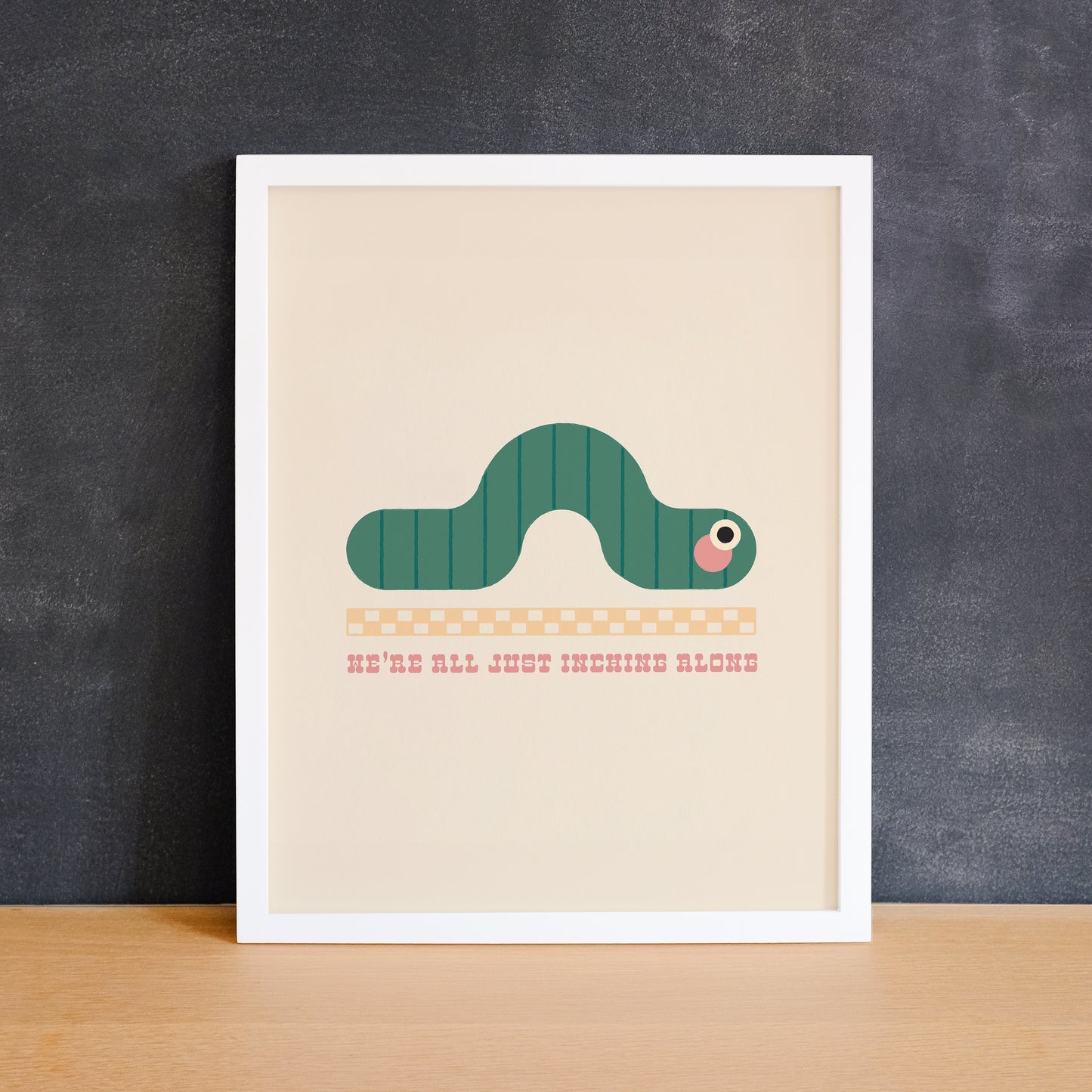Cute print of an inch worm with a ruler and the text "we're all just inching along". Made in Canada by Mad Love Creative Co.