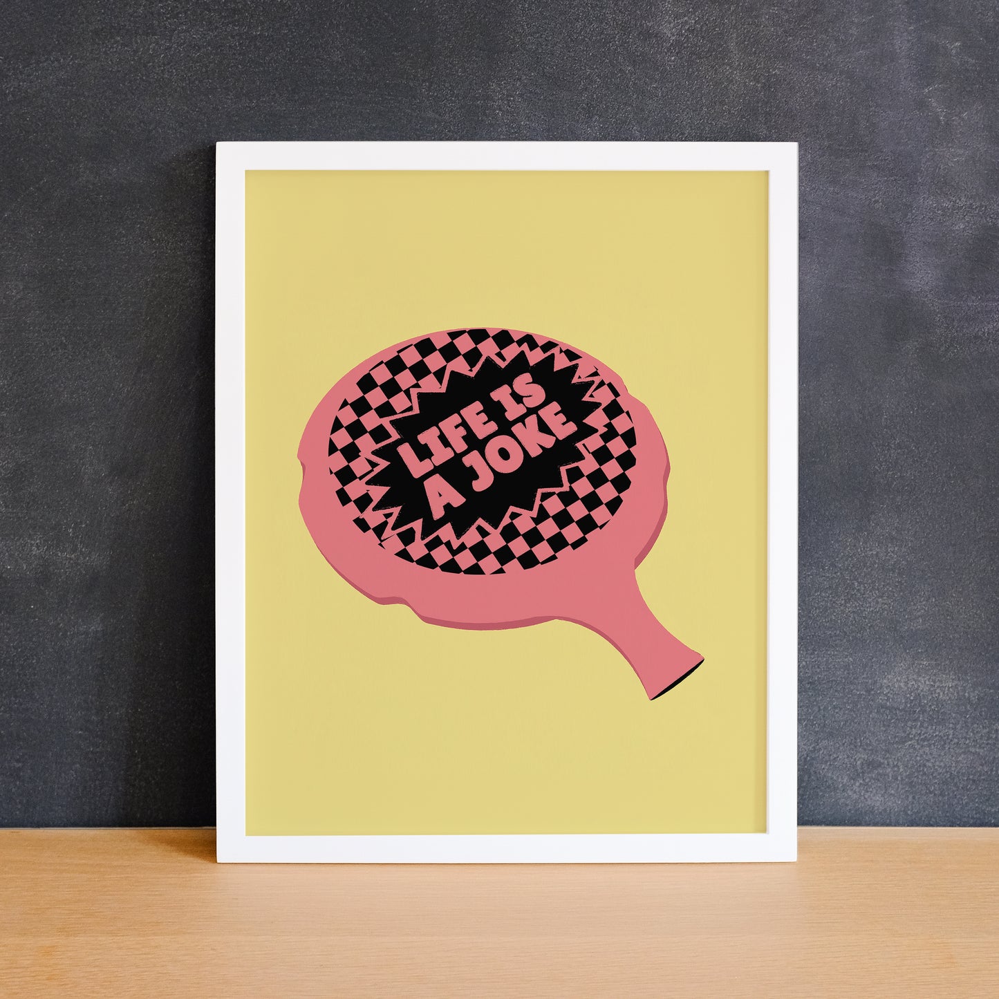 Funny print of a whoopee cushion on a yellow background with the phrase "life is a joke". Made in Canada by Mad Love Creative Co.