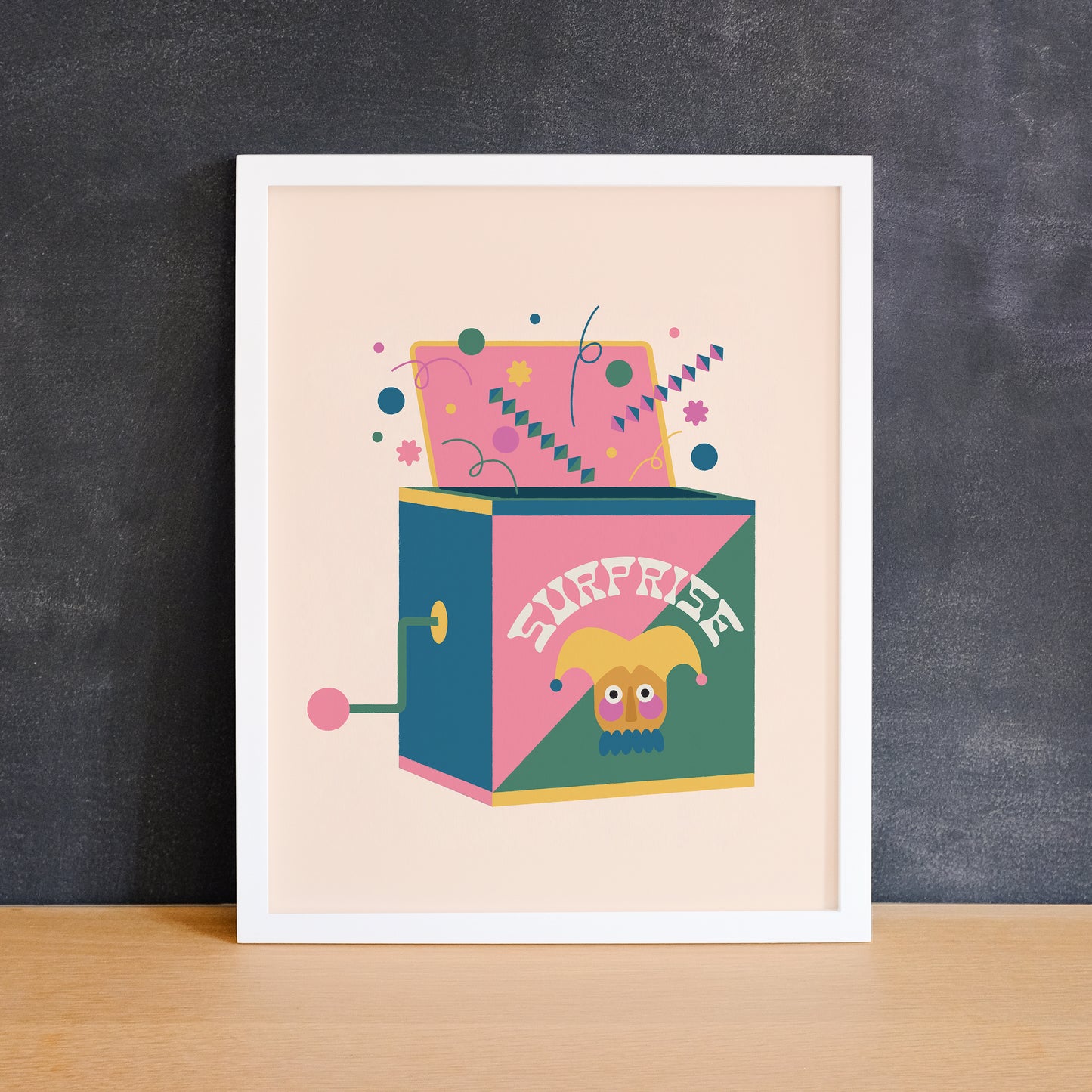 Colourful print of a jack in the box that says "surprise". Made in Canada by Mad Love Creative Co.