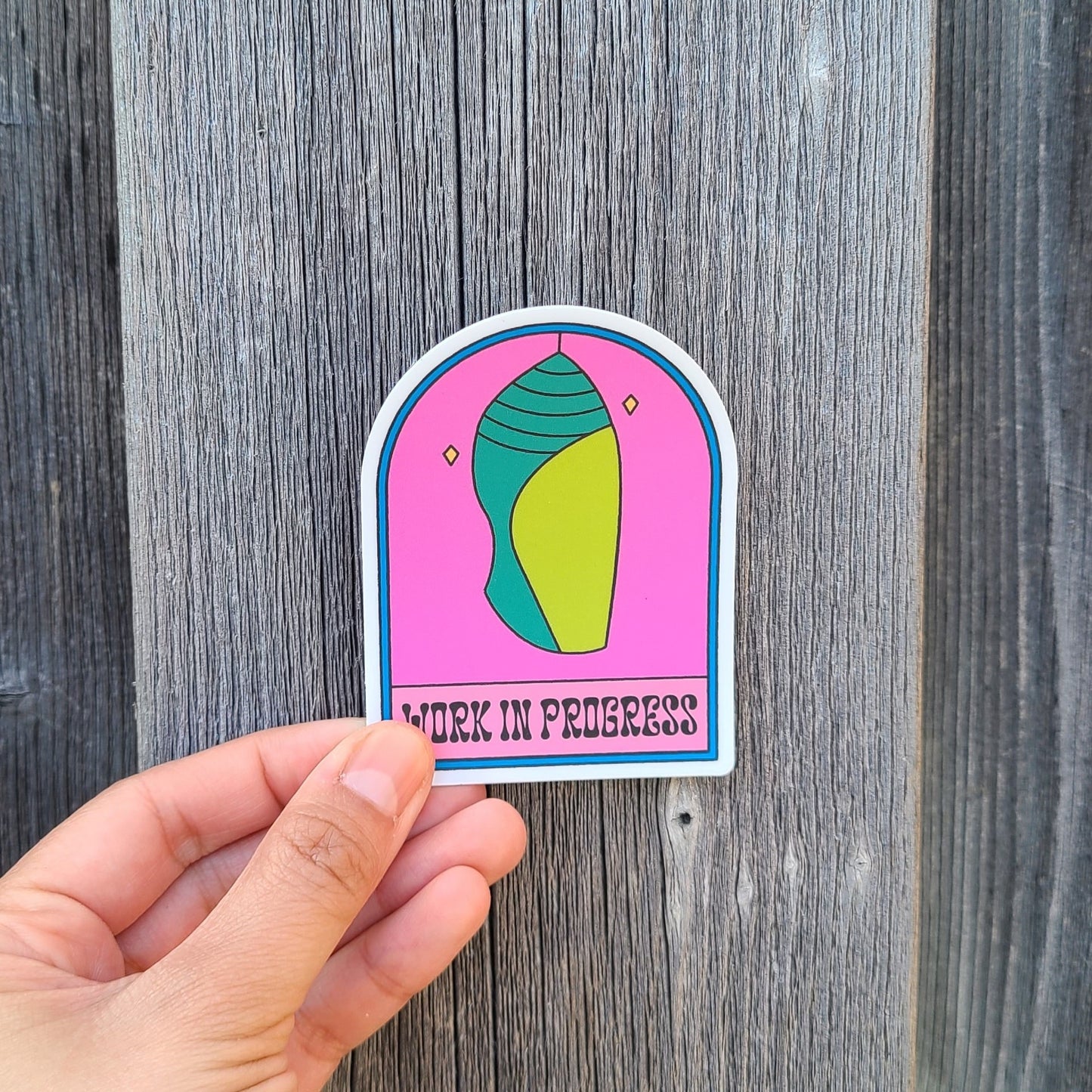 Cute sticker of a cocoon with the text "work in progress". Made in Canada by Mad Love Creative Co.