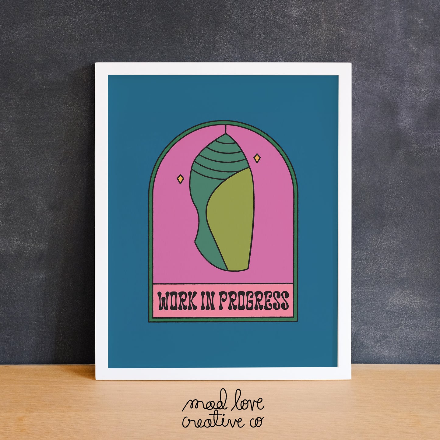 Illustration of a cocoon or chrysalis with the phrase "work in progress". Made in Canada by Mad Love Creative Co.