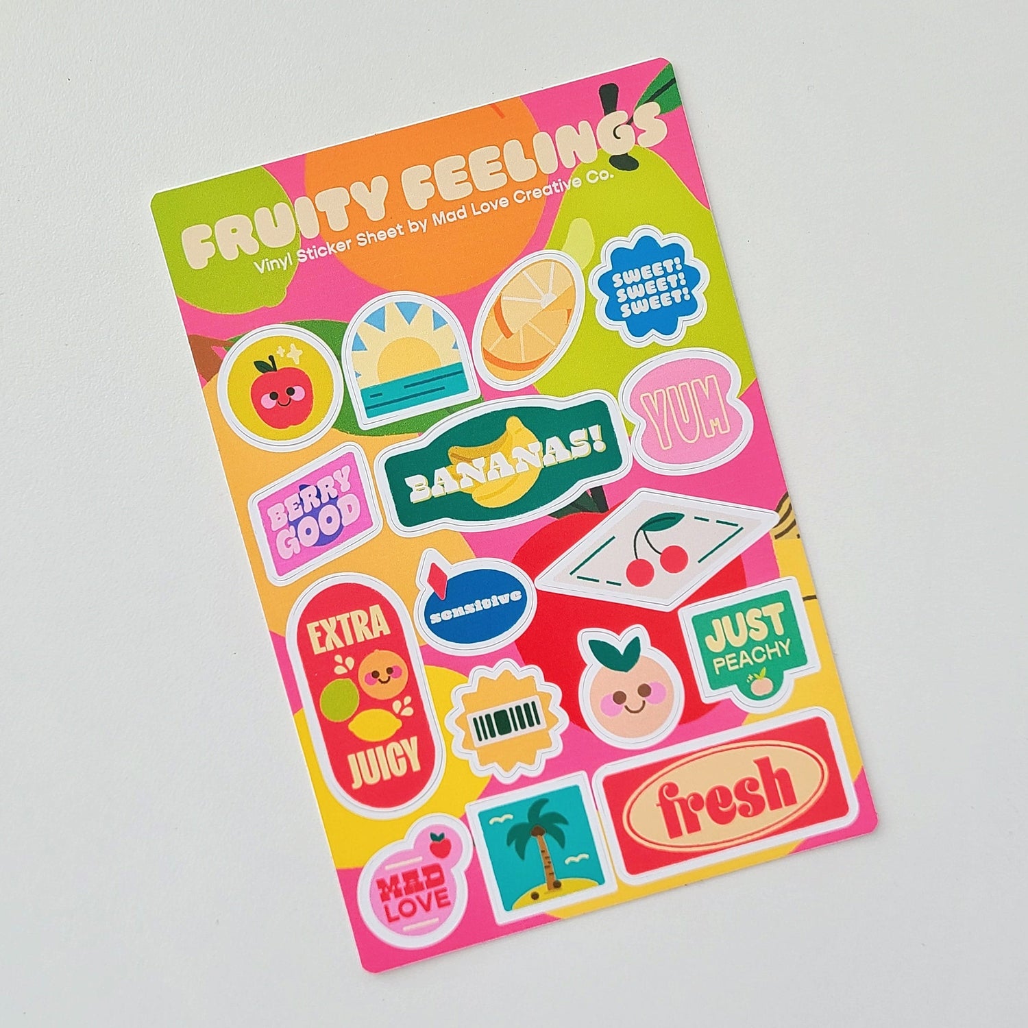 Sticker sheet with colorful fruit-themed designs on a gray background