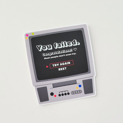 Vintage-style electronic device with a screen displaying text on a light gray background