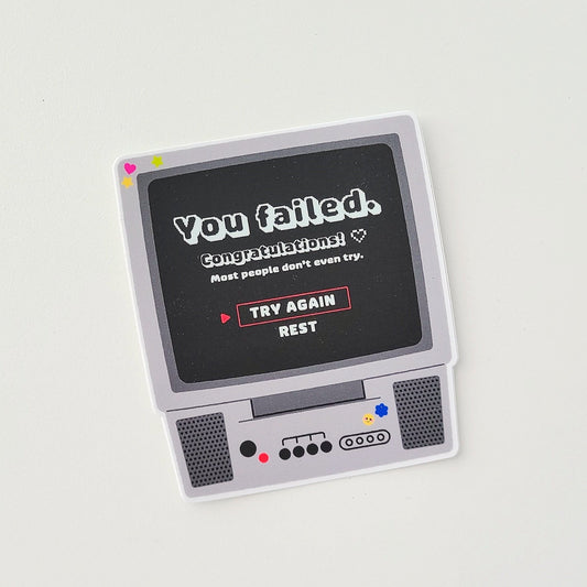 Vintage-style electronic device with a screen displaying text on a light gray background