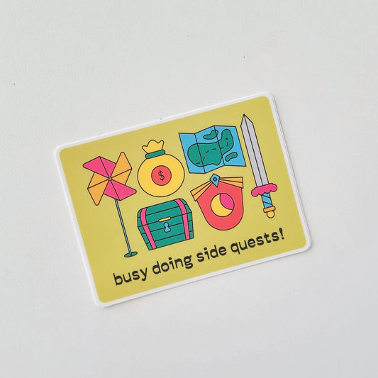 Sticker with colorful icons and text 'busy doing side quests!' on a light gray background