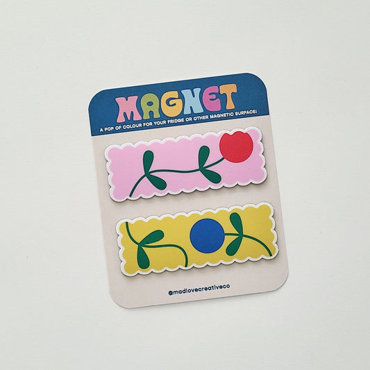 Packaged magnets with floral designs on a white background