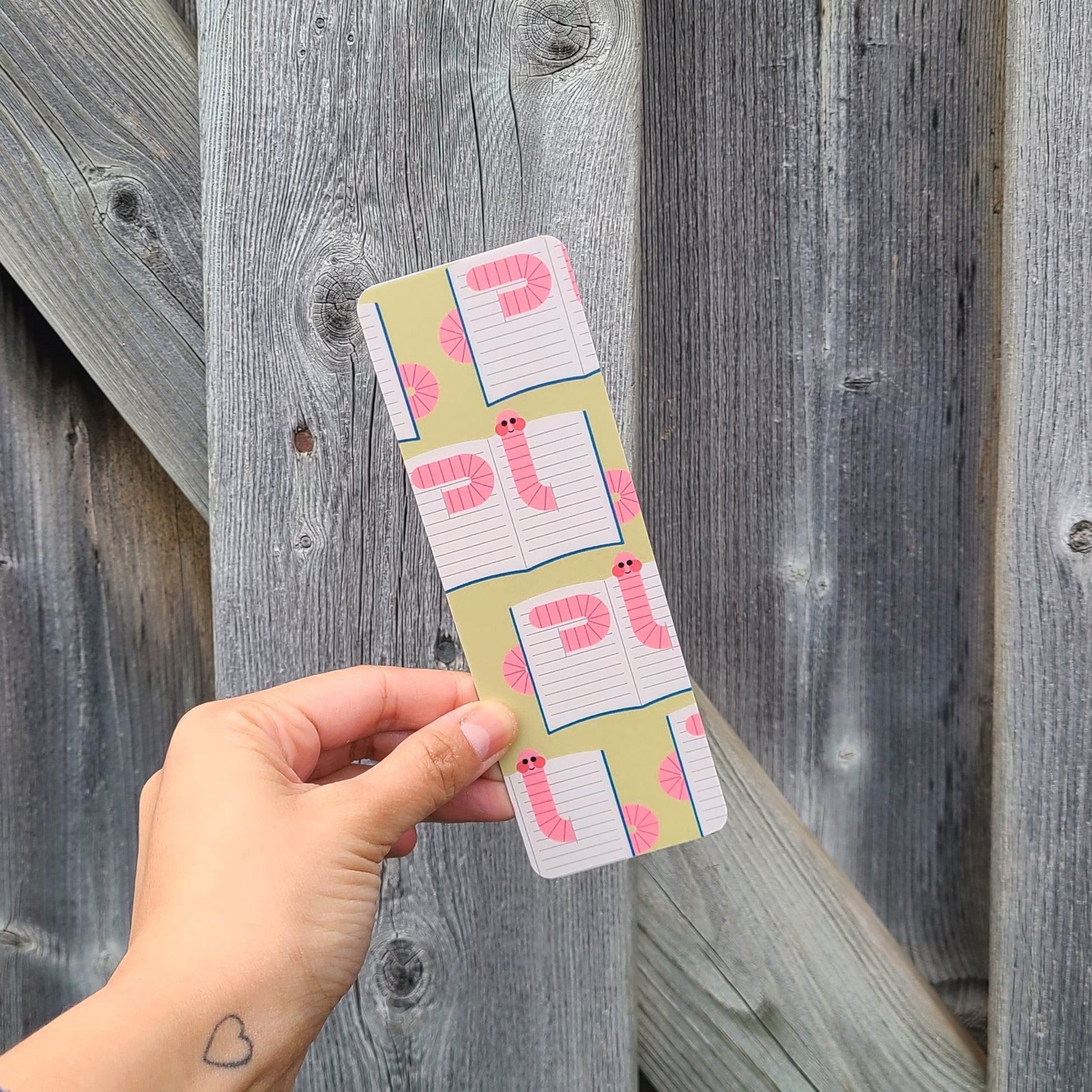 Cute bookmark featuring a pattern of bookworms. Made in Canada by Mad Love Creative Co.