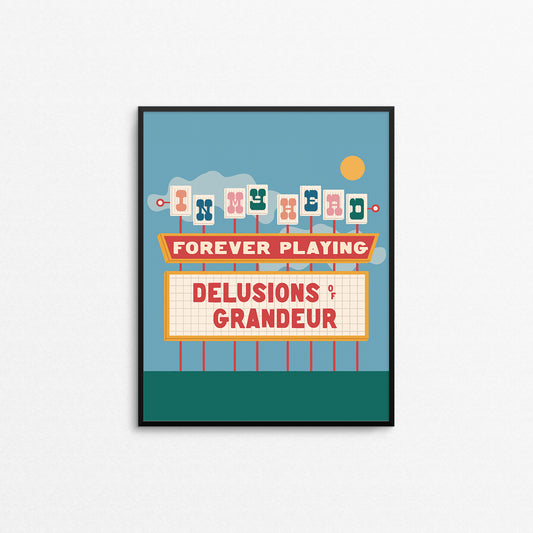 Colourful print of a retro neon movie theatre sign that says "delusions of grandeur". Made in Canada by Mad Love Creative Co. 