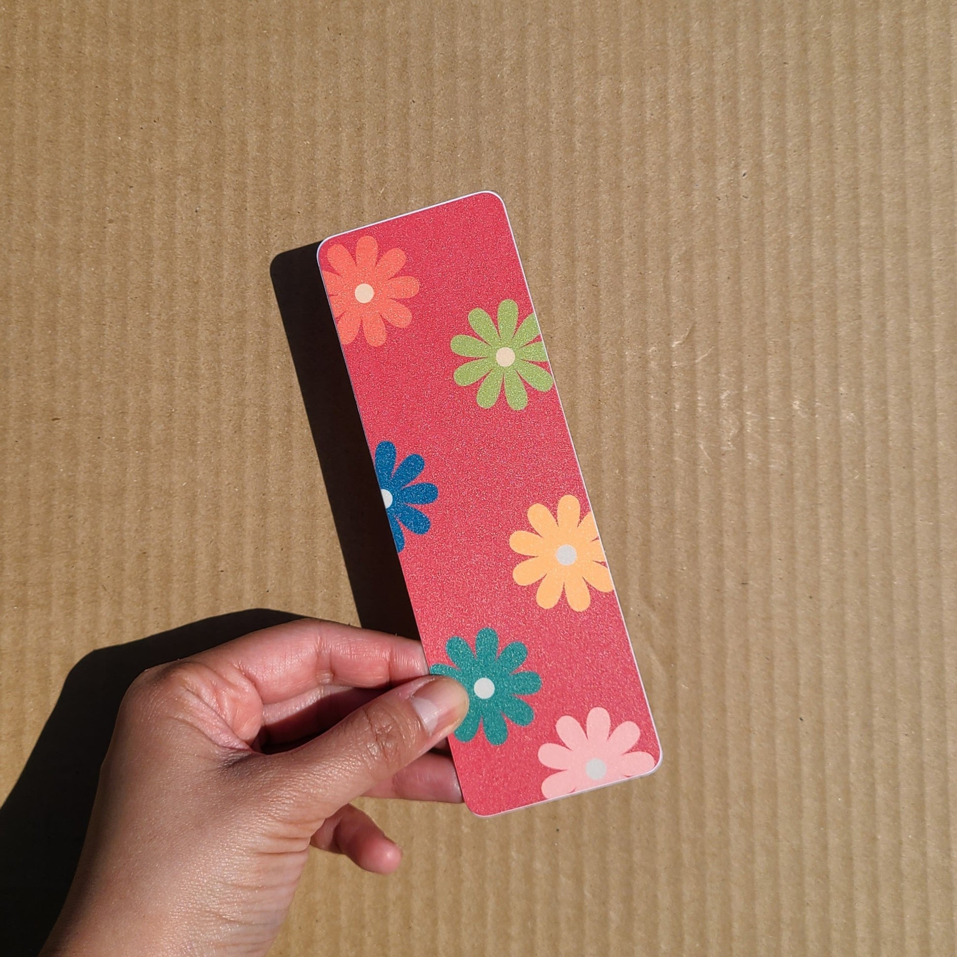 Colourful bookmark featuring a pattern of flowers in retro colours. Made in Canada by Mad Love Creative Co. 