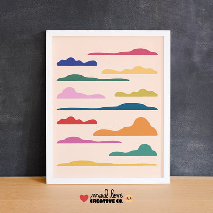 Framed artwork mockup with colorful cloud shapes on a purple wall. Made in Canada by Mad Love Creative Co. 
