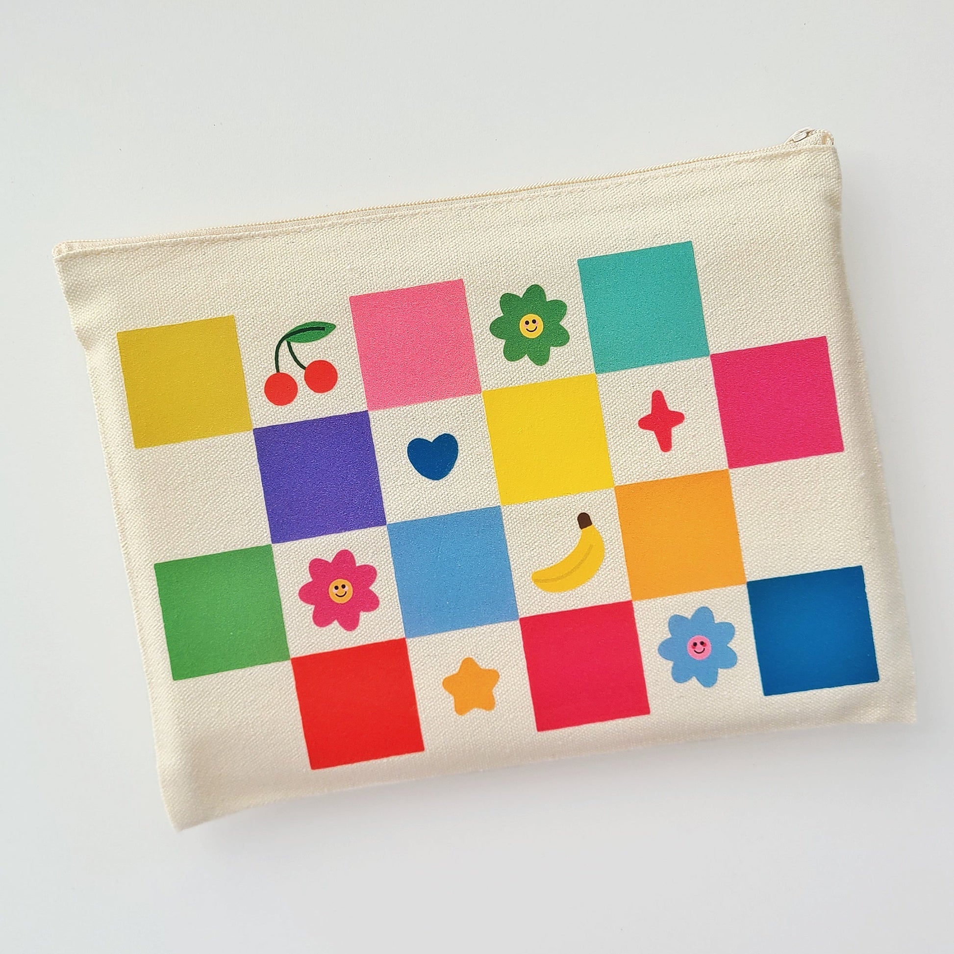 Canvas pouch with colorful square patterns and icons on a white background