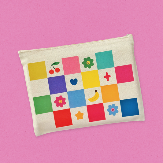 Small pouch with colorful square patterns on a pink background