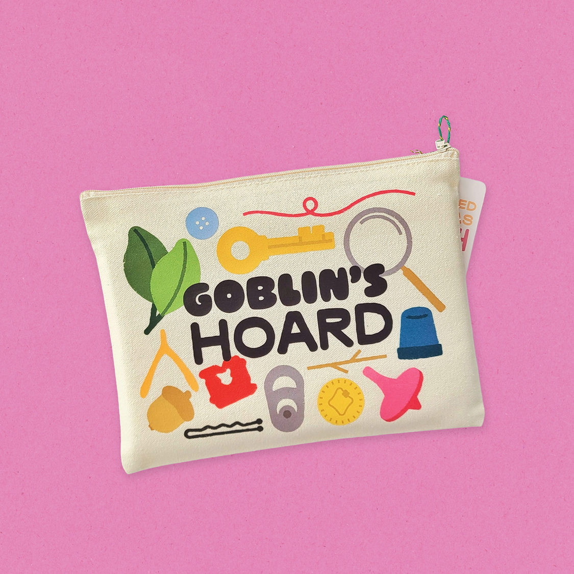 Canvas pouch with 'Goblin's Hoard' design on a pink background