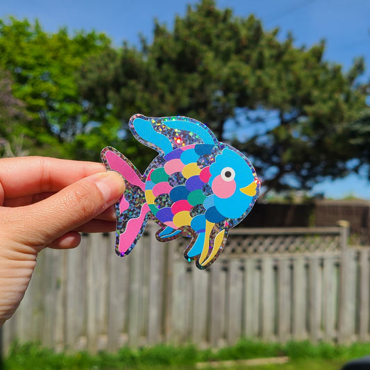 Cute glitter vinyl sticker of the book character Rainbow Fish. Made in Canada by Mad Love Creative Co.