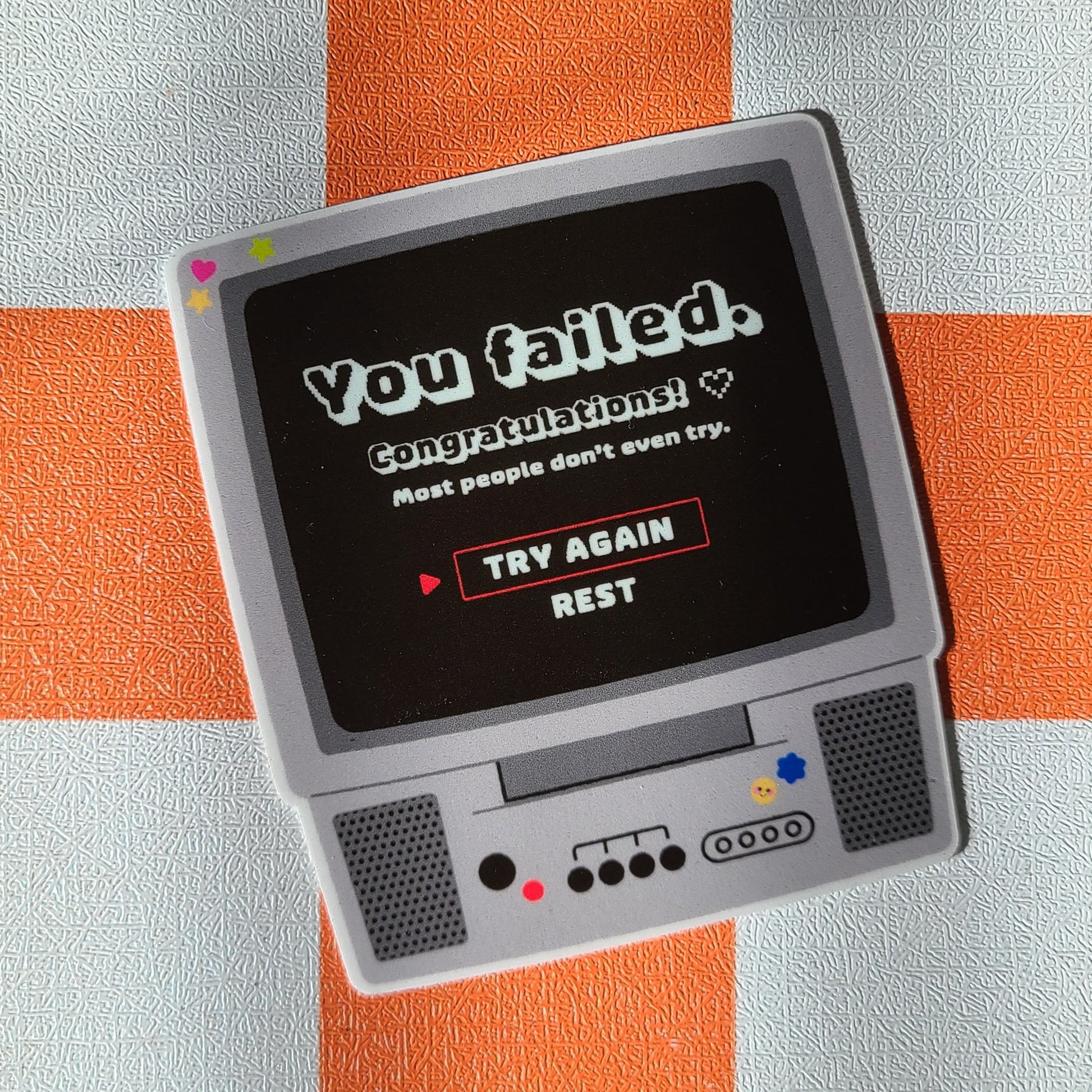 Small vintage-style TV on a checkered orange and white tablecloth