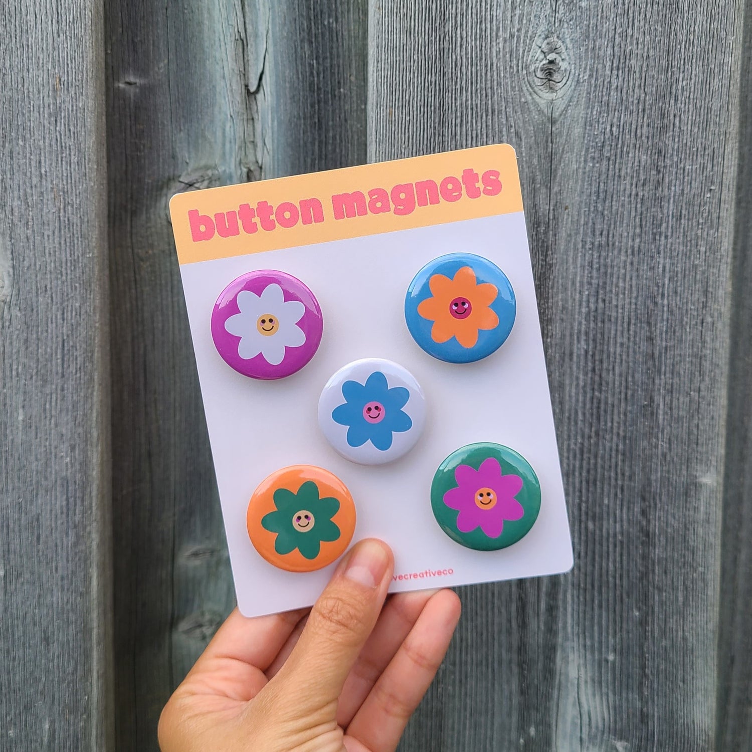 Cute button magnet set made in Canada by Mad Love Creative Co. featuring different coloured flowers with smiley faces.