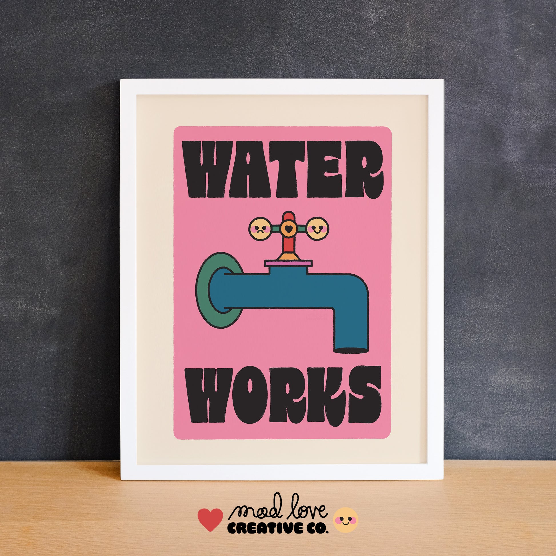 Framed Monopoly-inspired poster with a water faucet graphic and 'Water Works' text on a pink background. Made in Canada by Mad Love Creative Co. 