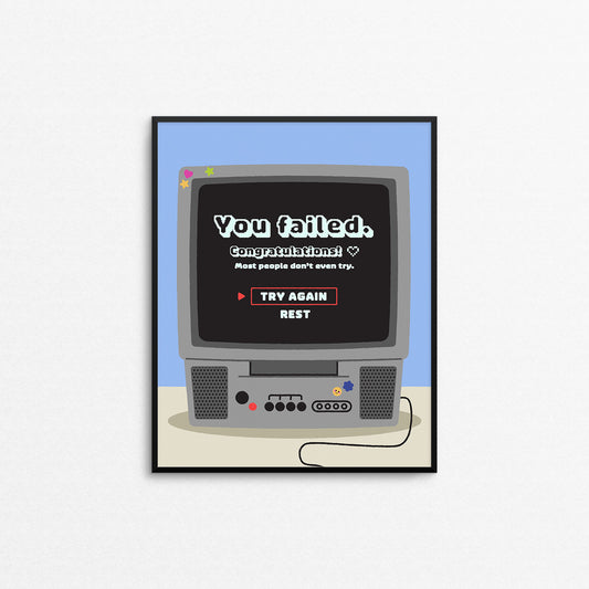 Cute motivational print of a retro 2000s style tv with a video game fail screen that says "you failed, congratulations!". Designed and made in Canada by Mad Love Creative Co.